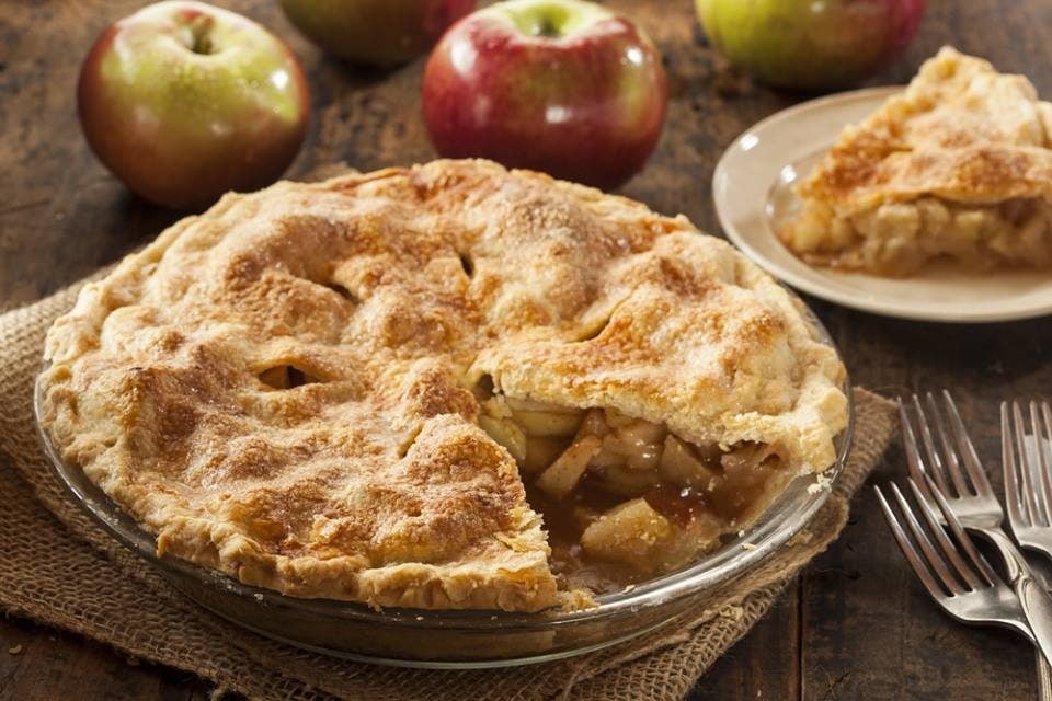 Apple cider pie on wooden table