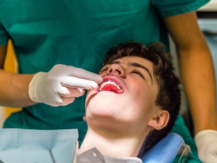 Orthodontist inspecting braces