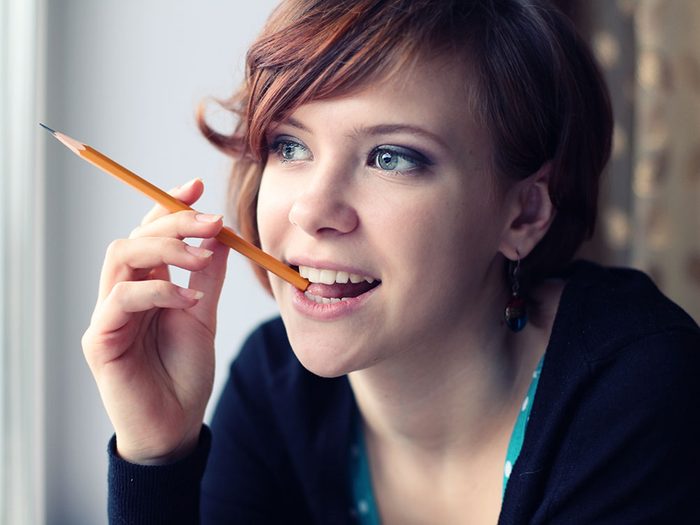 Girl chewing on pencil