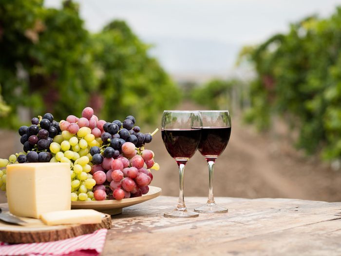 Wine on rustic wood table in vineyard