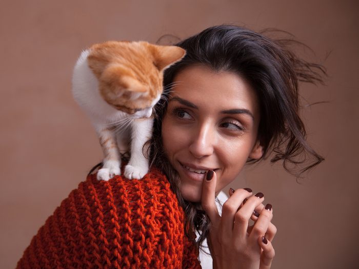Woman with cat on her shoulder