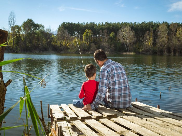 Father and son at the dock fishing
