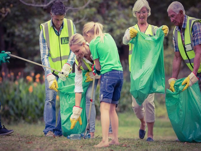 Family volunteering to clean garbage on Father's Day