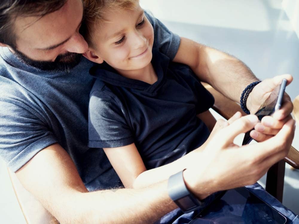 Father and son using smartphone