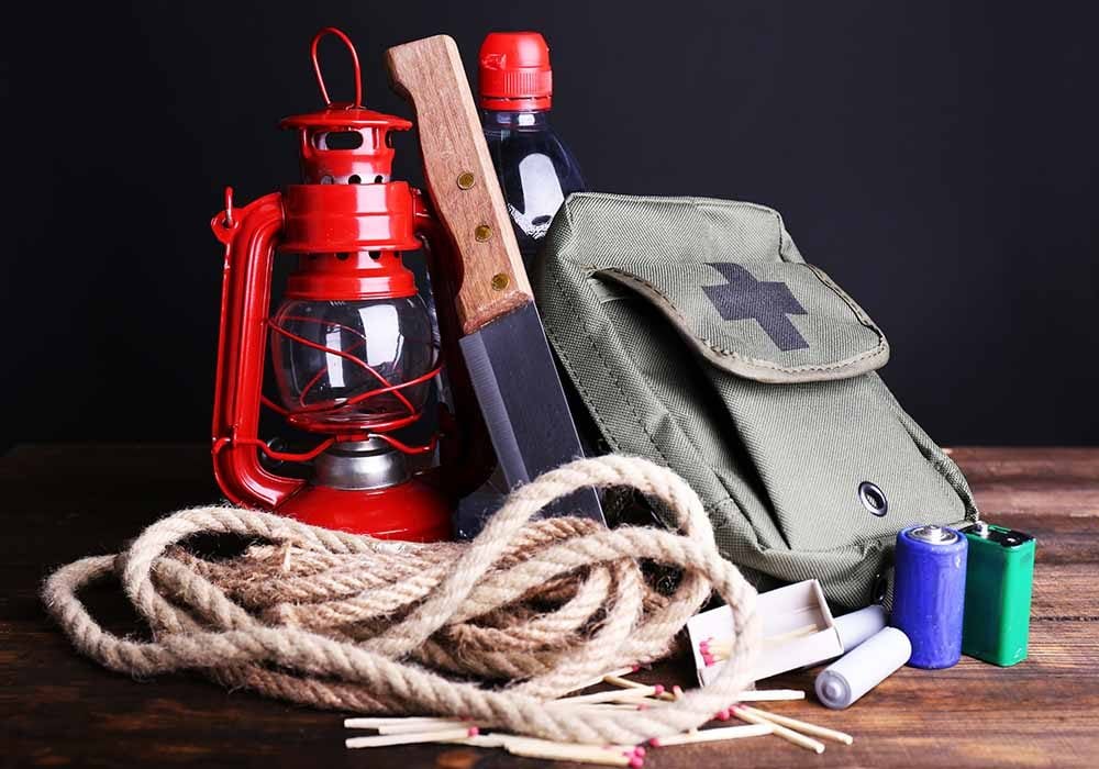 Emergency kit with rope, knife, batteries and water bottle