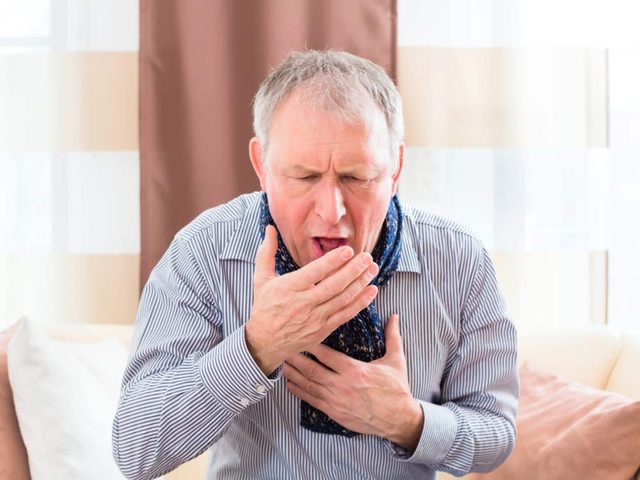 Elderly man coughing