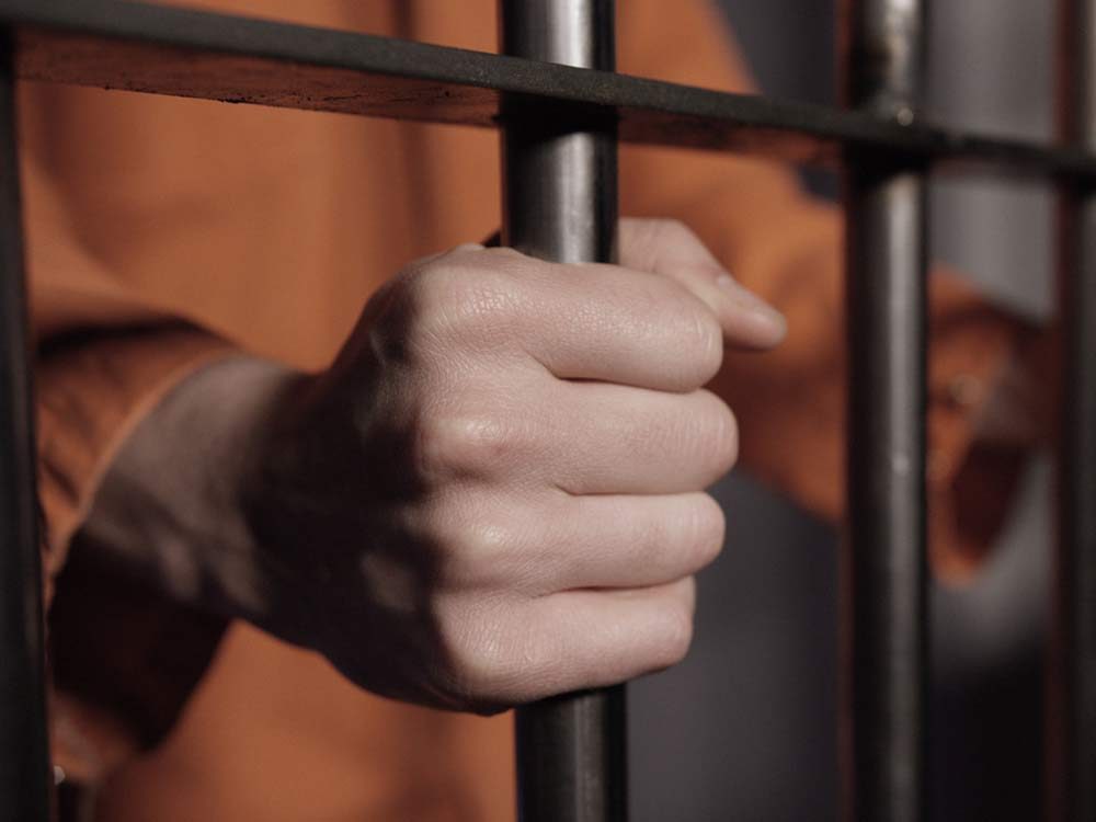 Man in jail behind bars