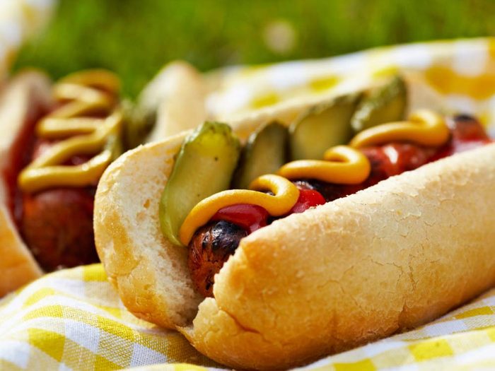 Hot dog with mustard and pickles