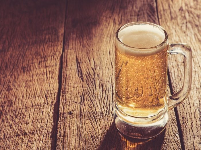 A cold glass of beer on a wooden table