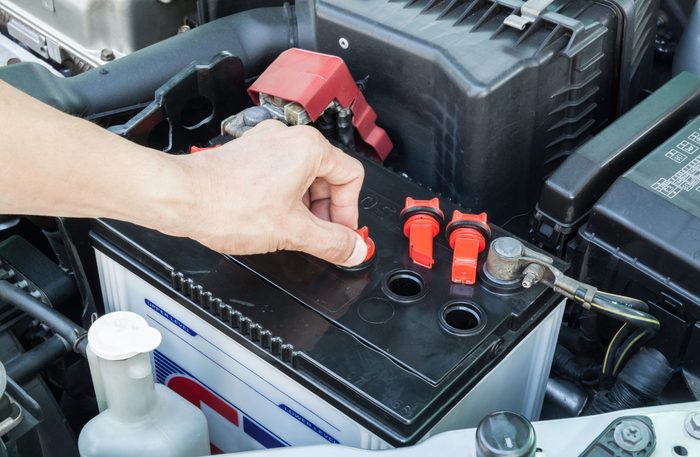 Person checking car battery