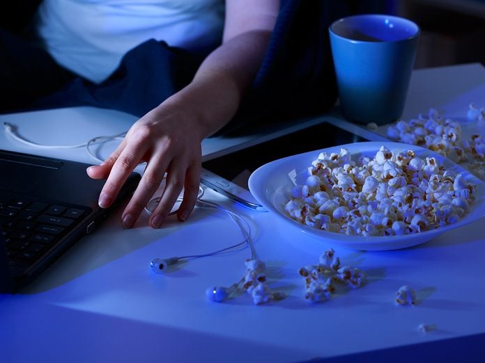 Close-up of spilled popcorn on table and laptop