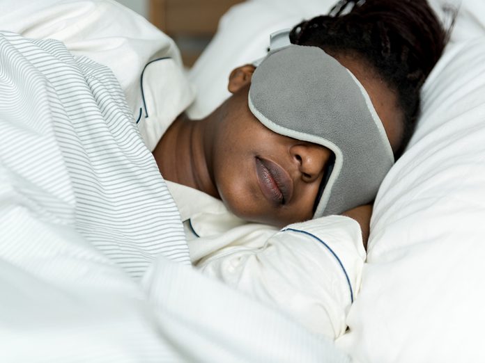 A woman sleeping with a sleeping mask
