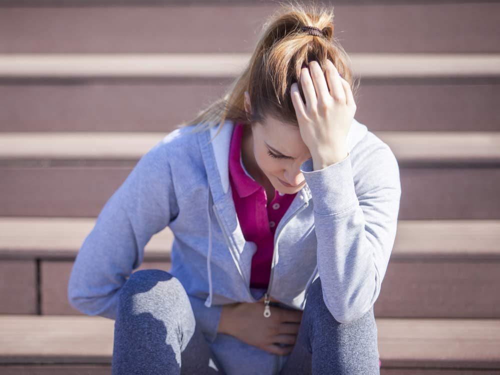 Jogger woman with stomach pain