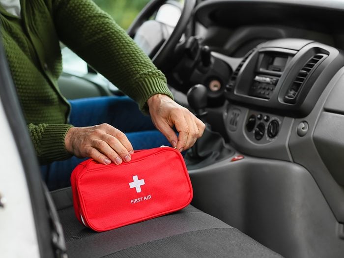Man with first aid kit in car