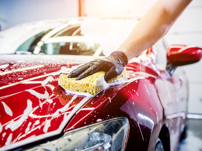 Car cleaning tips - man washing red car