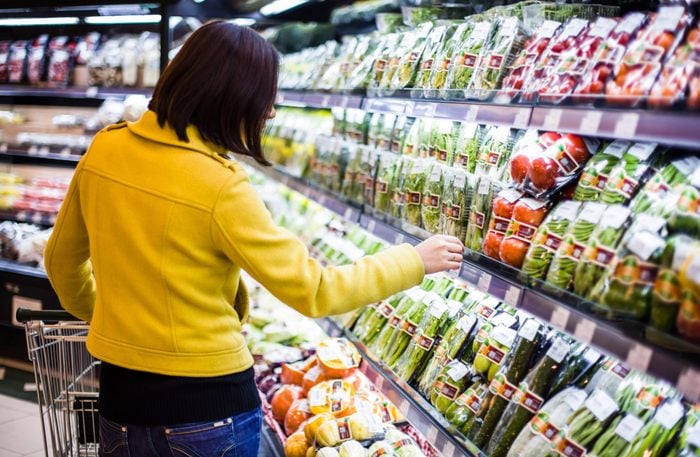 Woman looking at produce at the grocery store