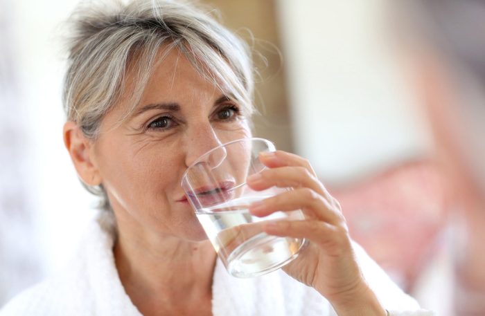 Elderly woman drinking water