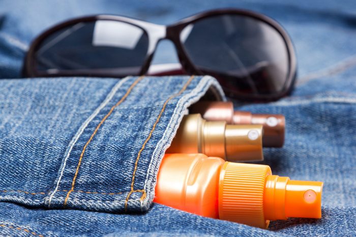 Cosmetic sunscreen products in jeans pocket