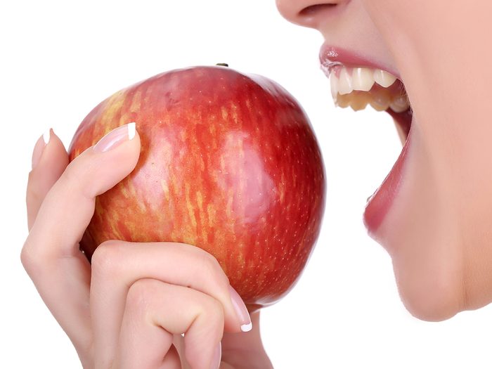 Apple benefits - woman eating apple