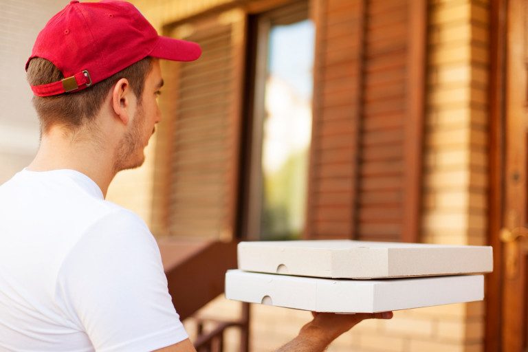 Delivery man delivering pizza