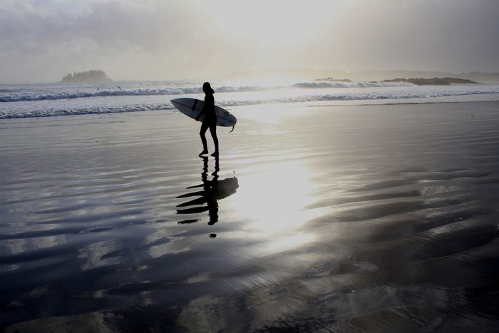 Woman surfing at Tofino Beach