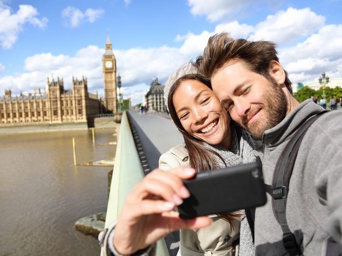 Couple taking a selfie at Westminster Palace in London