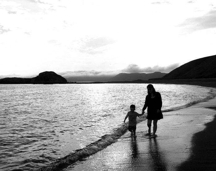 Mother and son walking at dusk