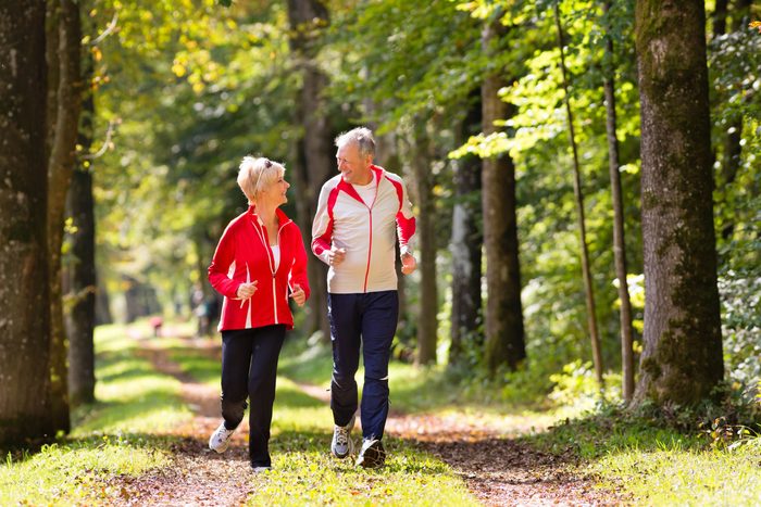Elderly couple jogging in park