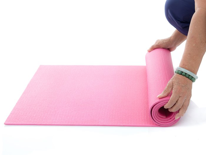 Rolling up a yoga mat for Pilates