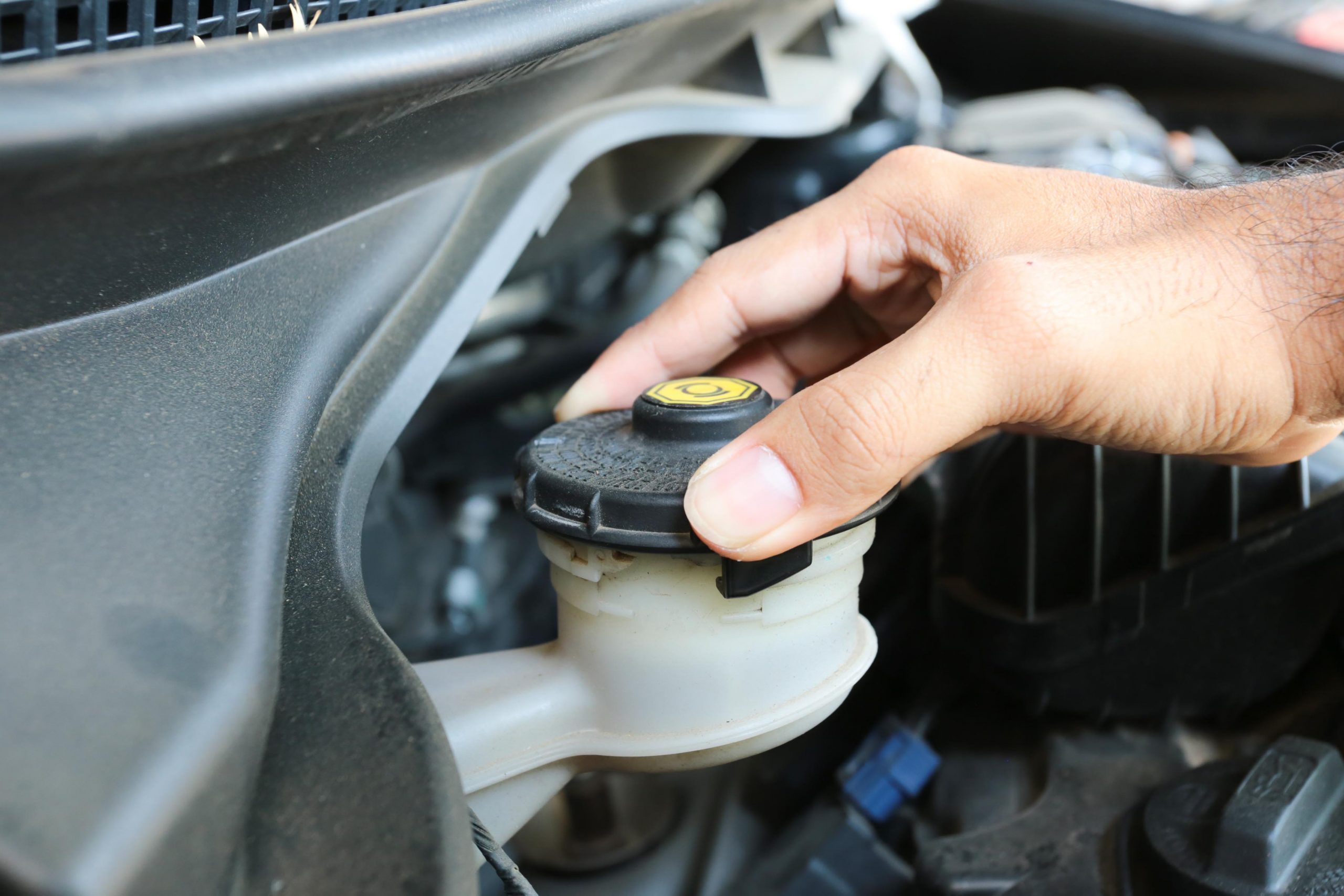 car repair tips - Man checking his brake fluid