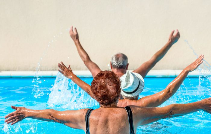 Elderly people exercising in pool