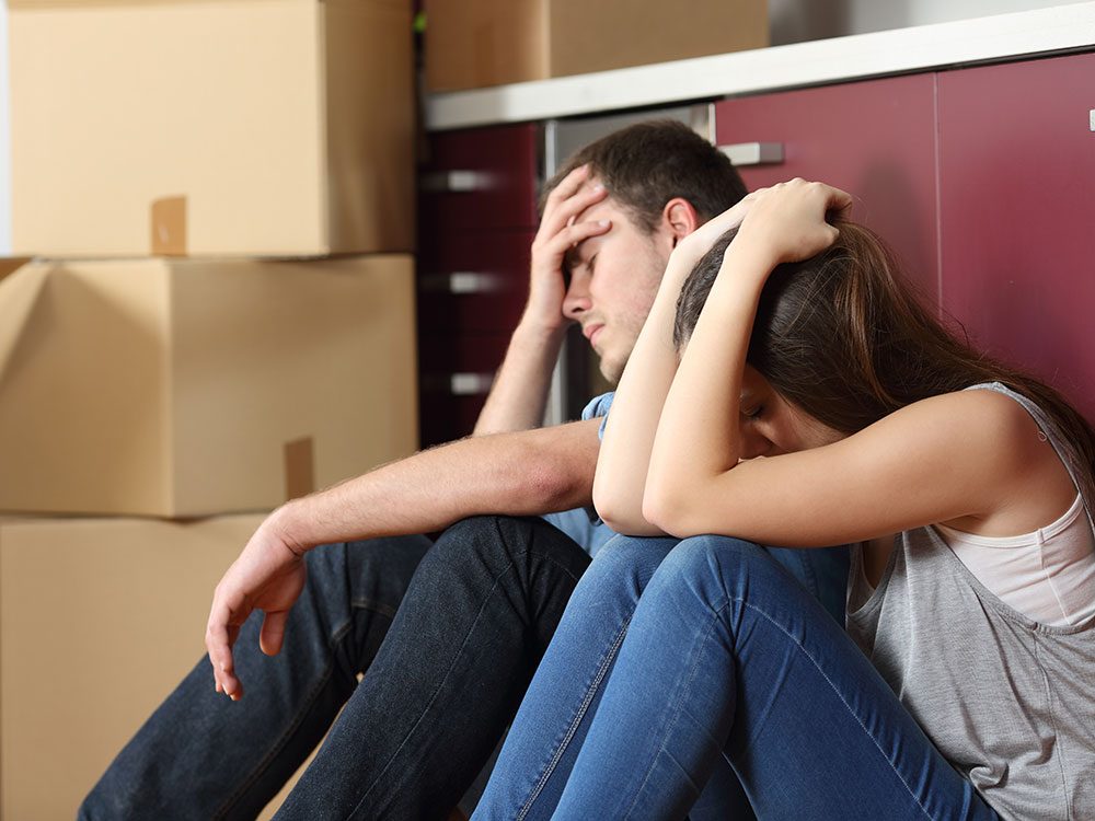 Young frustrated couple moving in to rental apartment