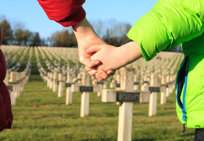 Mother and child at cemetery during Remembrance Day