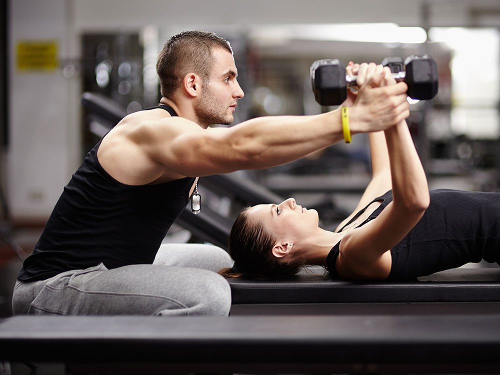 Trainer with woman working out