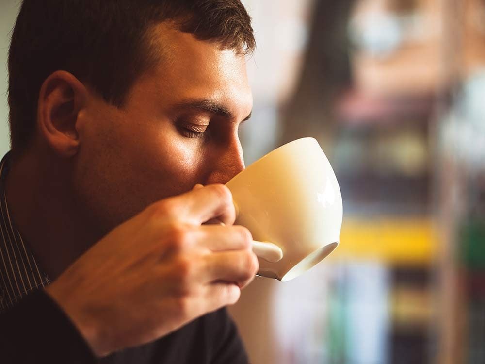 Man drinking tea in cafe
