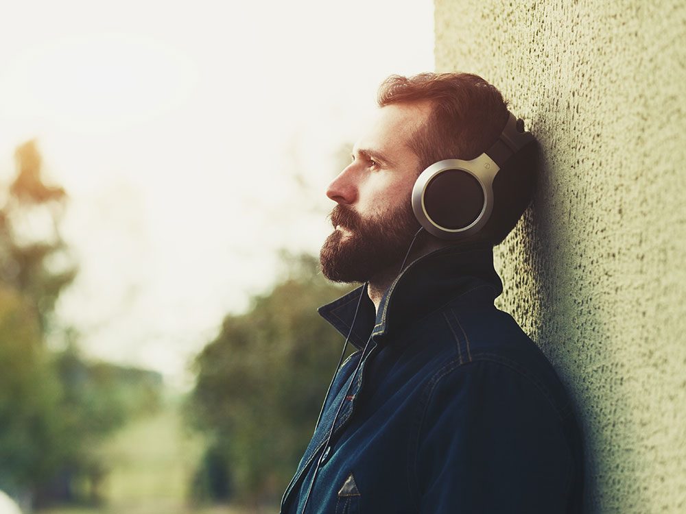 Depressed man listening to music