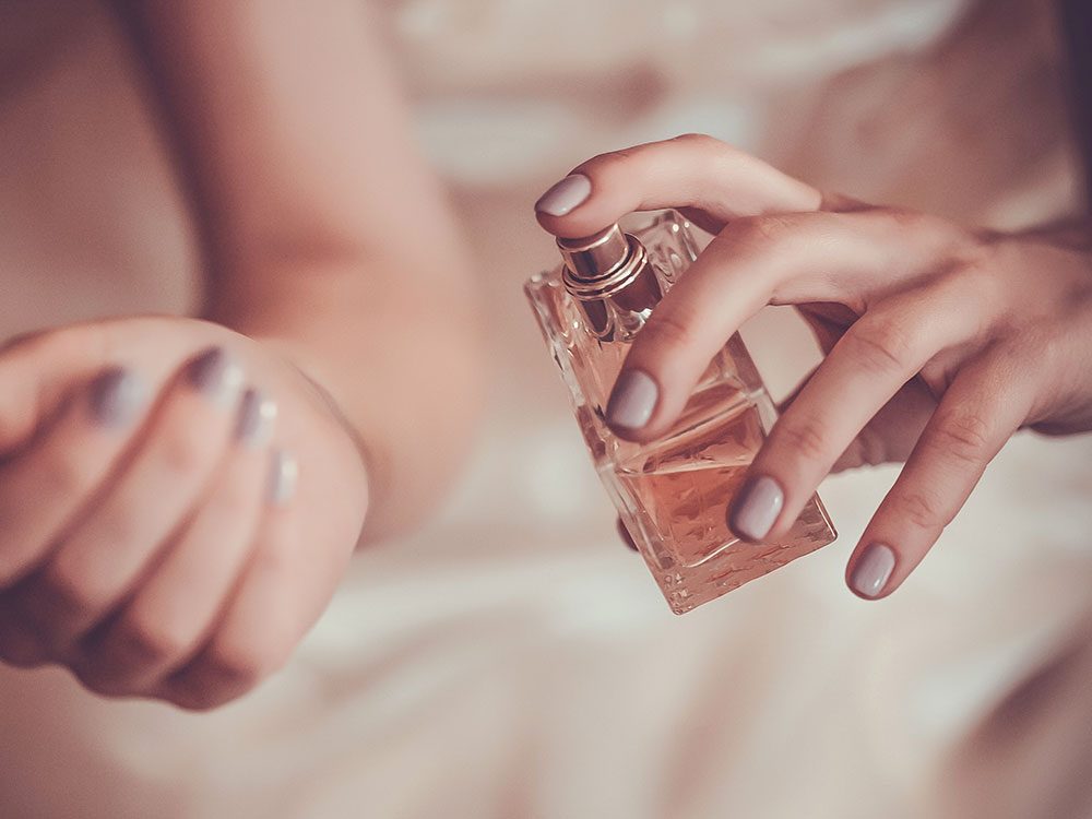 Woman applying fragrance