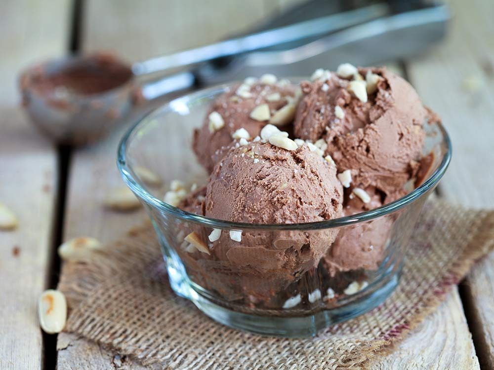 Chocolate ice cream in bowl on wooden table