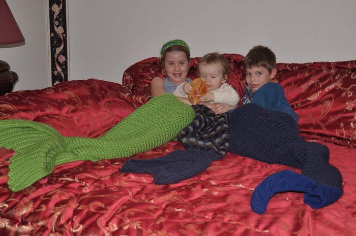handmade - Three children wearing fish blankets