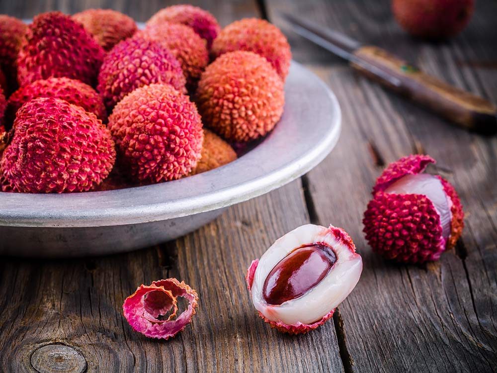 Red lychee fruit in bowl