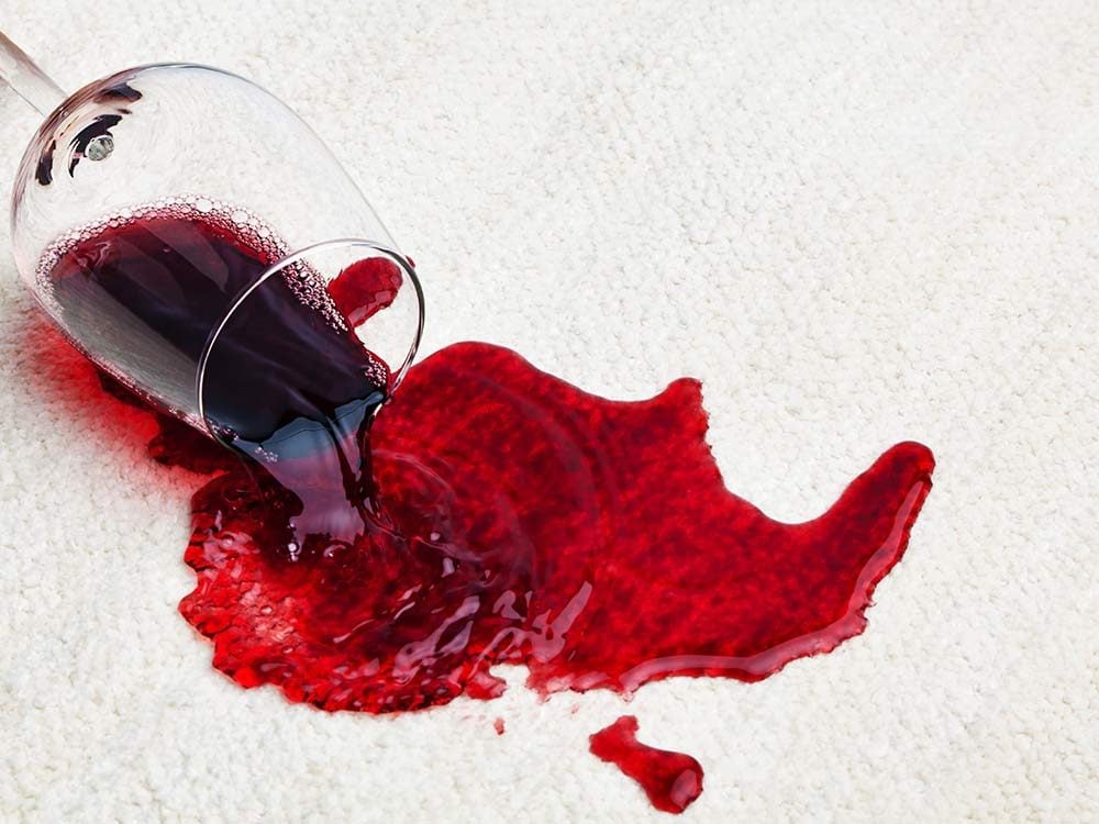 Red wine spill on white carpet