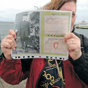 Janey in Portland, Maine, holding a photo of her dad, along with his 1914 boarding pass
