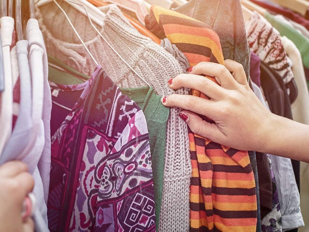 Woman looking through clothes at garage sale