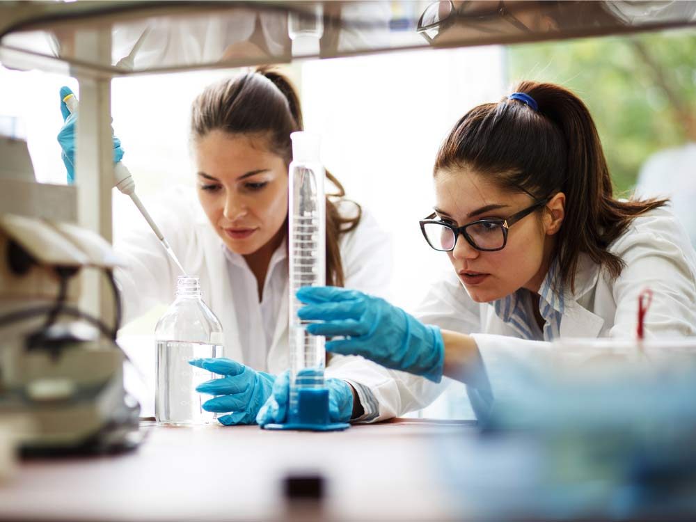 Two scientists conducting experiment in a lab