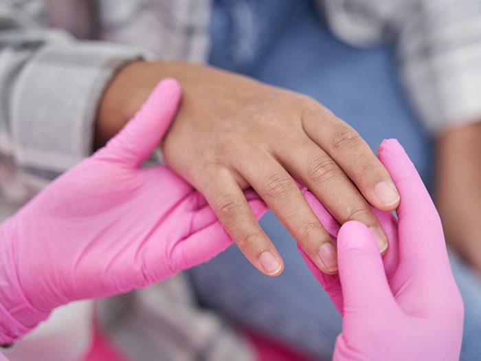 Doctor examining patient's hands