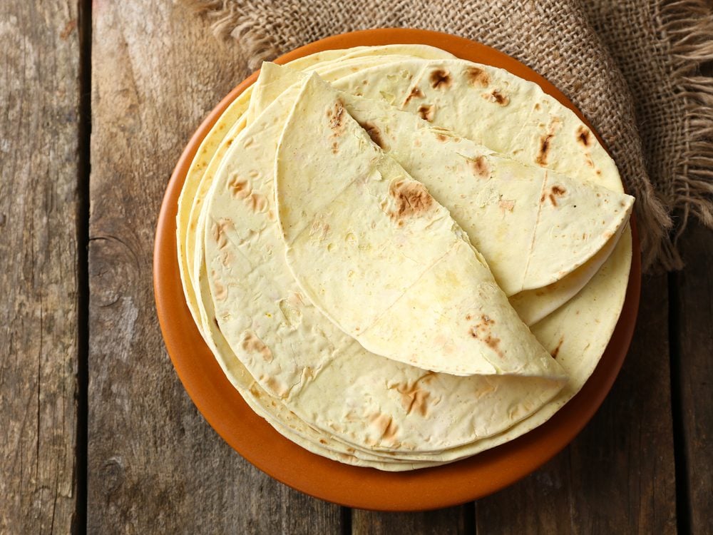 Sprinkle a whole-wheat tortilla with 2 ounces grated, low-fat cheddar cheese