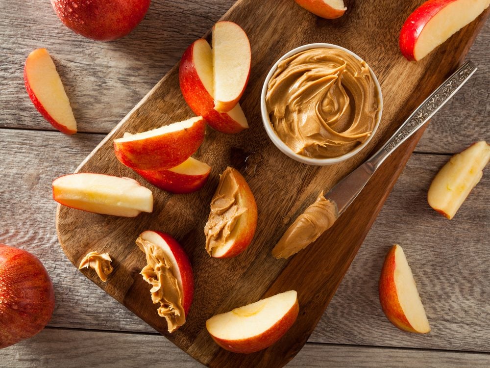 Spread apple slices with peanut butter