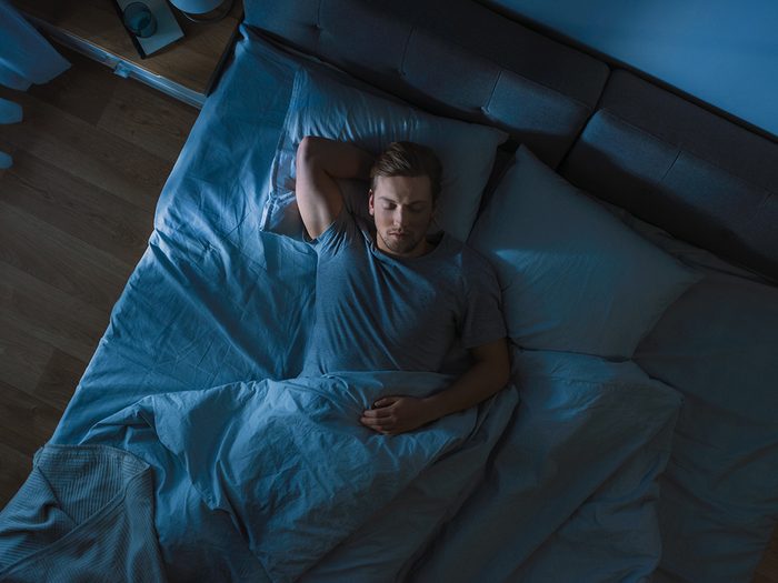 How much sleep do you need? Man sleeping in bed at night