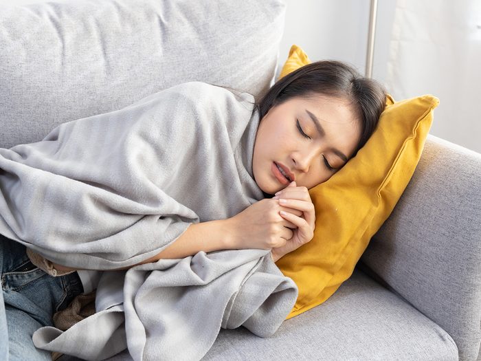 How much sleep do you need? Woman sleeping on couch
