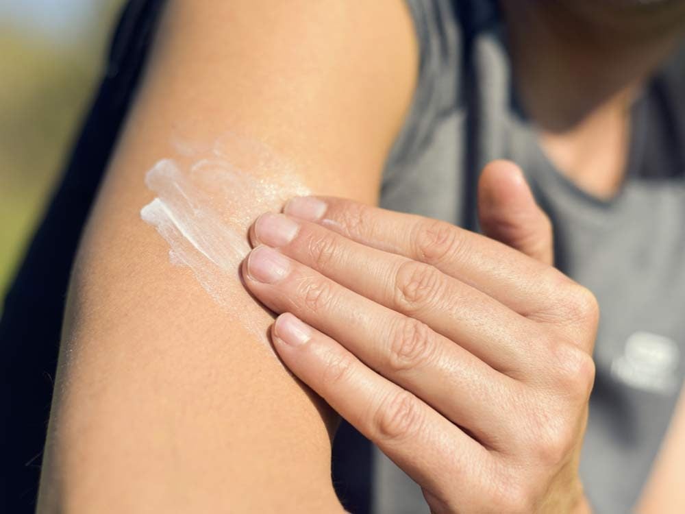 Applying sunscreen to arm